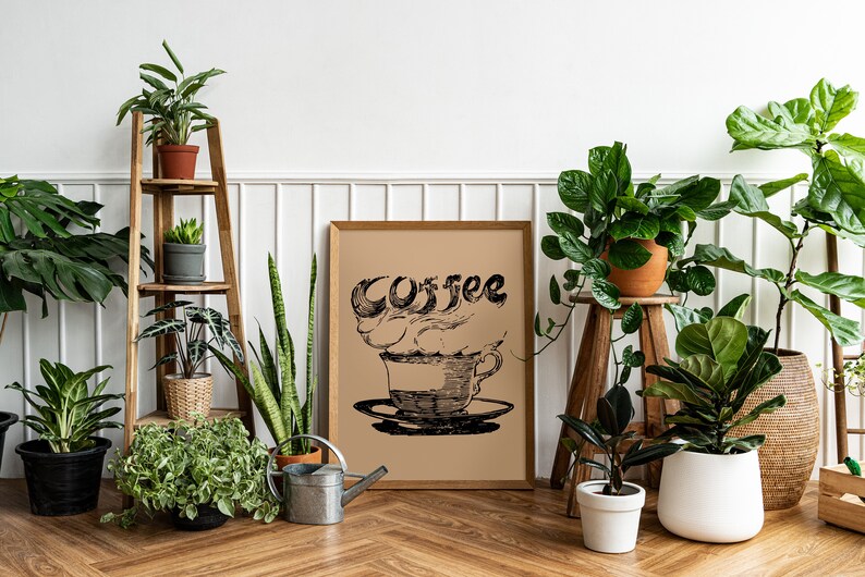 May include: A white wall with a wooden shelf unit holding various potted plants. A framed print with a black and white illustration of a coffee cup with steam and the word "Coffee" is hanging on the wall. There are also several potted plants on the floor.