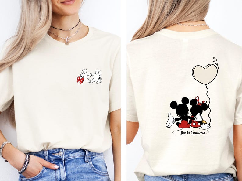 May include: Cream-coloured t-shirt with a cartoon design. The front shows a white bunny with a red bow and a heart. The back features Mickey and Minnie Mouse with a heart-shaped balloon and the names "Joe & Samantha".