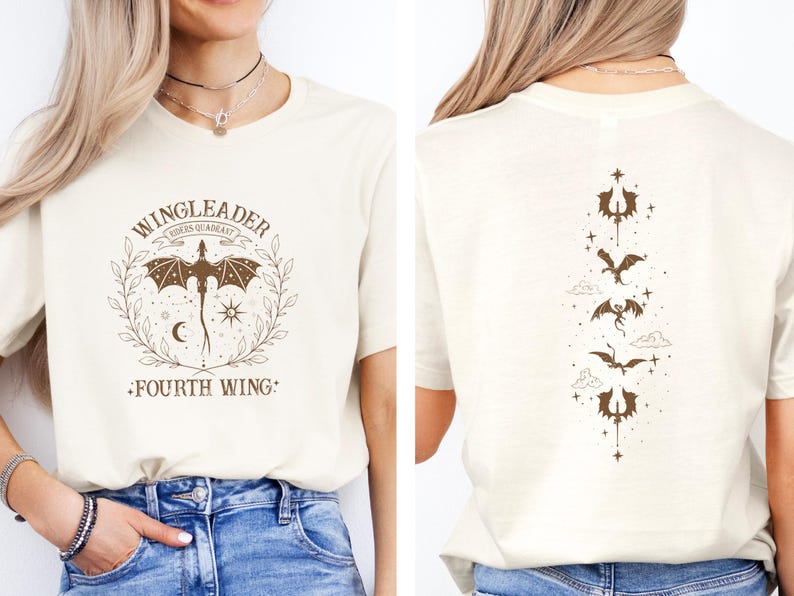 May include: A white t-shirt with a brown graphic of a dragon and the text "WINGLEADER RIDERS SQUADRAST FOURTH WING". The back of the shirt has a vertical design of five dragons with stars and clouds.