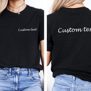 May include: Black t-shirt with short sleeves and the text "Custom text" printed on the front and back in white.