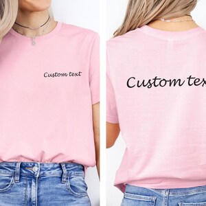 May include: A pink t-shirt with the text "Custom text" on the front and back.
