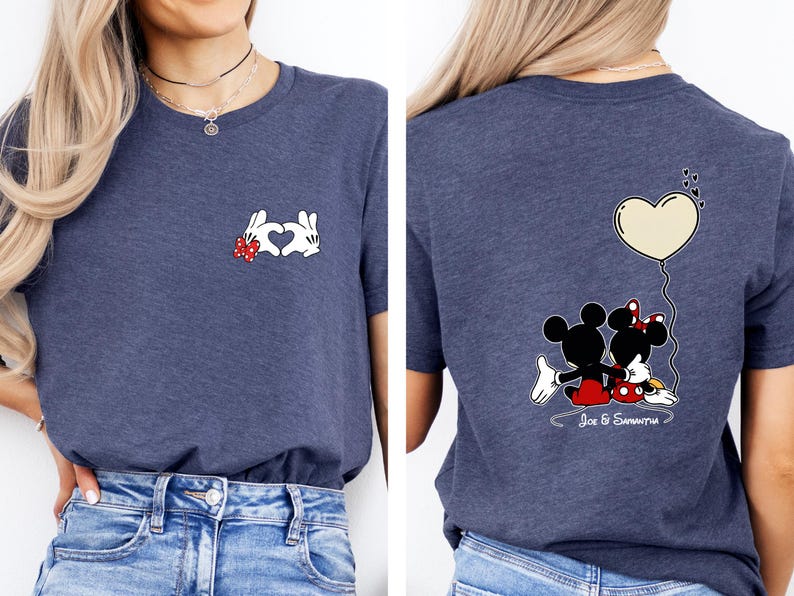 May include: A navy blue t-shirt with a Mickey Mouse and Minnie Mouse design. The front displays white gloved hands forming a heart with a red bow. The back shows Mickey and Minnie with a heart balloon and the names "Joe & Samantha".