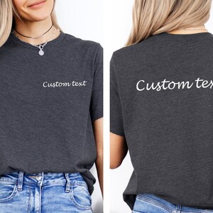 May include: A dark grey t-shirt with the text "Custom text" printed on the front and back in white.