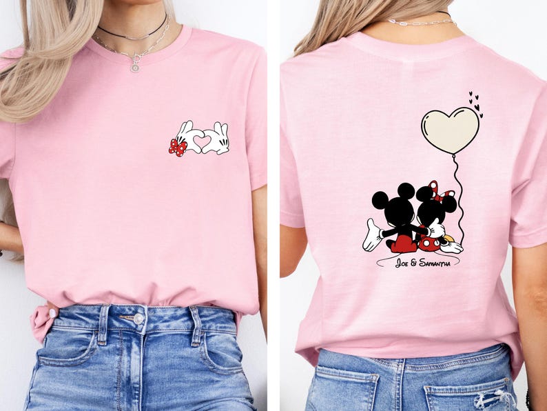 May include: Pale pink t-shirt with a cartoon rabbit design and a heart on the front. The back of the shirt features Mickey and Minnie Mouse with a heart-shaped balloon. The names "Joe & Samantha" are printed below the characters.