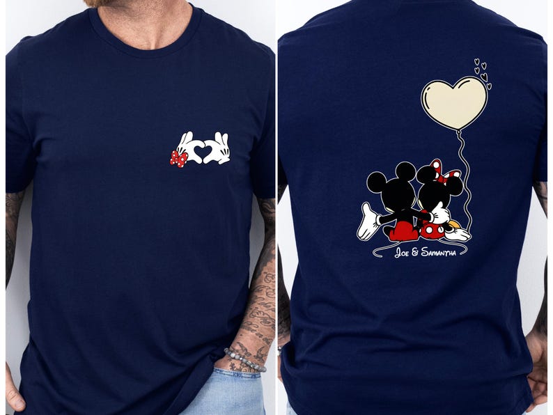 May include: Navy blue t-shirt with a Mickey and Minnie Mouse design. The front shows a heart made of white gloved hands with a red bow. The back features the couple with a heart balloon and the names "Joe & Samantha".