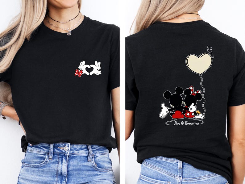 May include: Black t-shirt with a heart made of white cartoon hands and a red bow. The back of the shirt shows Mickey and Minnie Mouse with a heart-shaped balloon and the names "Joe & Samantha".