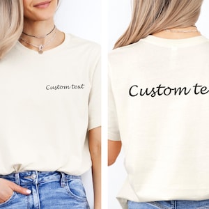 May include: A white t-shirt with the text "Custom text" printed on the front and back in black.