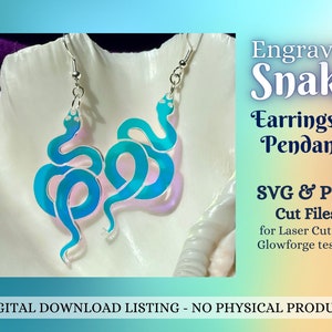 May include: A pair of blue and iridescent snake earrings or pendants. The earrings are made of acrylic and are laser cut. The image includes the text "Engraved Snake Earrings or Pendants SVG & PDF Cut Files for Laser Cutters Glowforge tested!"