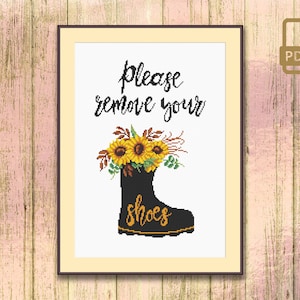 May include: A black boot with sunflowers on top and the text "Please remove your shoes" in a white frame.