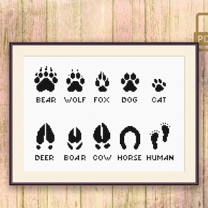 Pode incluir: Ilustração em preto e branco de pegadas de animais, incluindo pegadas de urso, lobo, raposa, cão, gato, veado, javali, vaca, cavalo e humano. A imagem está em uma moldura branca com um fundo branco.