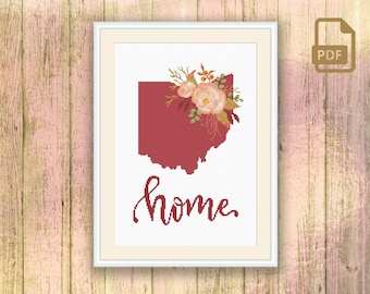 May include: Cross stitch pattern featuring a red outline of the state of Ohio with a floral bouquet in the upper right corner. The text "home" is written in cursive below the state outline.