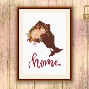 May include: A cross-stitch pattern featuring the outline of the Canadian province of Ontario with a floral design and the word "home" in cursive script.