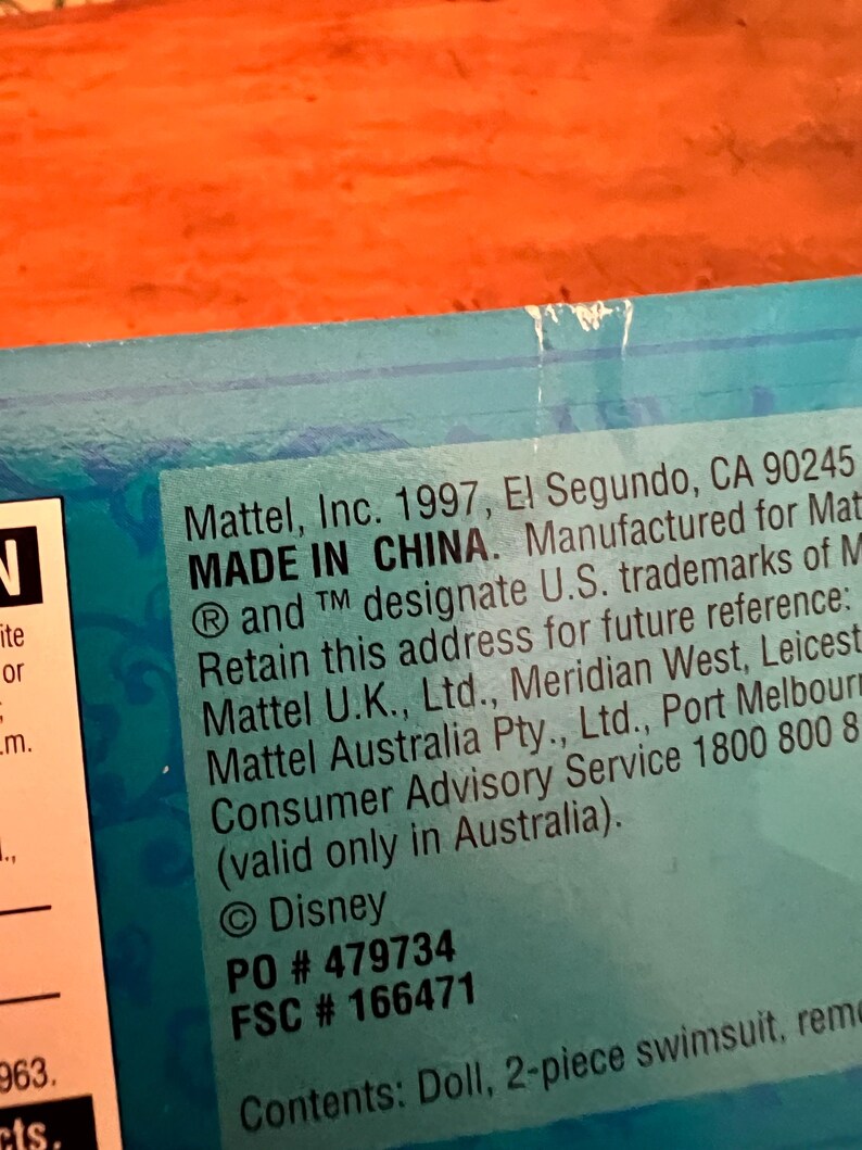 May include: A blue product packaging label featuring black text that reads Mattel, Inc. 1997, El Segundo, CA 90245, MADE IN CHINA. Manufactured for Mattel. Retain this address for future reference: Mattel U.K., Ltd., Mattel Australia Pty., Ltd. Disney PO # 479734 FSC # 166471.