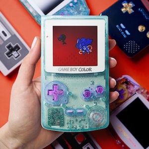 Couleur Game Boy Suicune | Coquillage pailleté bleu sarcelle, Boutons chromés violets | Rétro personnalisé vintage modifié