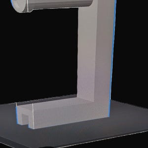 Puede incluir: Un soporte de plástico gris impreso en 3D con un soporte cilíndrico en la parte superior. El soporte está diseñado para sujetar un rollo de papel de cocina.