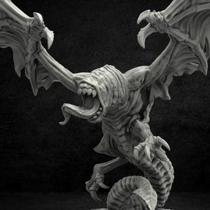 May include: A grey, detailed miniature of a monstrous creature with wings, a long tongue, and a serpentine body. The creature is posed in a menacing stance with its wings spread wide.