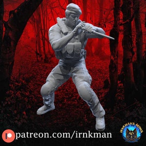 May include: A white plastic figurine of a soldier in a tactical pose, wearing a beret and holding a knife. The figurine is set against a red and black background.