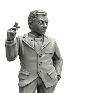 May include: A gray painted miniature figurine of a man wearing a suit and tie. The figurine is posed with one hand in his pocket and the other holding a small object. The figurine is standing on a gray base.