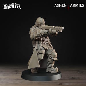 Op de afbeelding: Een grijze miniatuurfiguur van een soldaat in futuristisch pantser, met een geweer. De figuur staat op een zwarte basis. De woorden "Bite the Bullet" en "Ashen Armies" zijn zichtbaar.