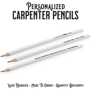 May include: Three white carpenter pencils with black laser engraved text. The text on the pencils reads "Company Name", "Measure Once, Cut Twice", and "Building Beautiful Homes".