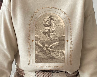 May include: Beige sweatshirt with a graphic print of Icarus falling from the sky. The text reads "Never regret thy fall, O Icarus of the fearless flight. For the greatest tragedy of them all is never to feel the burning light. The Myth of Icarus & Daedalus."
