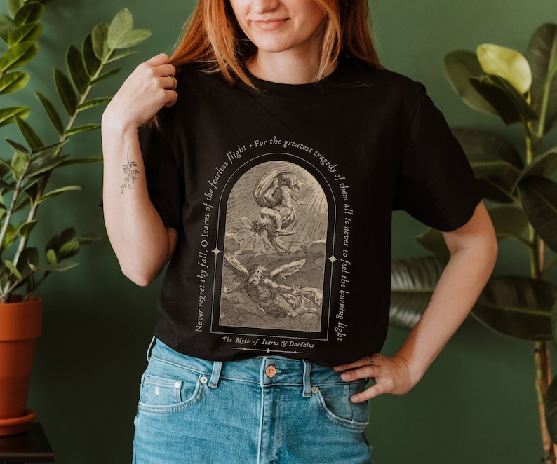 May include: Black t-shirt with a vintage illustration of Icarus falling from the sky. The text reads "Never regret thy fall, O Icarus of the fearless flight. For the greatest tragedy of them all is never to feel the burning light." The Myth of Icarus & Daedalus.