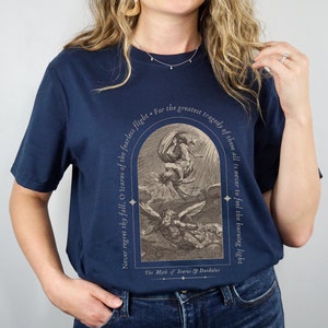 May include: A navy blue t-shirt with a vintage illustration of Icarus and Daedalus. The text reads "Never regret thy fall, O Icarus of the fearless flight. For the greatest tragedy of them all is never to feel the burning light. The Myth of Icarus & Daedalus."