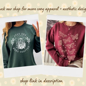 May include: Two sweatshirts with different designs. The first sweatshirt is dark green with a white graphic of a skeleton reading a book with the text "Just One More Chapter". The second sweatshirt is burgundy with a white graphic of butterflies.