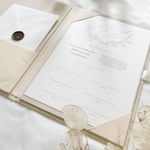 K&ouml;nnte beinhalten: Ein wei&szlig;er Ordner mit einem dekorativen Blumendesign auf der Vorderseite. Der Ordner ist ge&ouml;ffnet und zeigt ein leeres Formular mit dem Text "dini nikah belgeni" oben. Das Formular ist f&uuml;r eine Heiratsurkunde und enth&auml;lt Felder f&uuml;r den Namen des Br&auml;utigams, den Namen der Braut, das Datum und die Mitgift.
