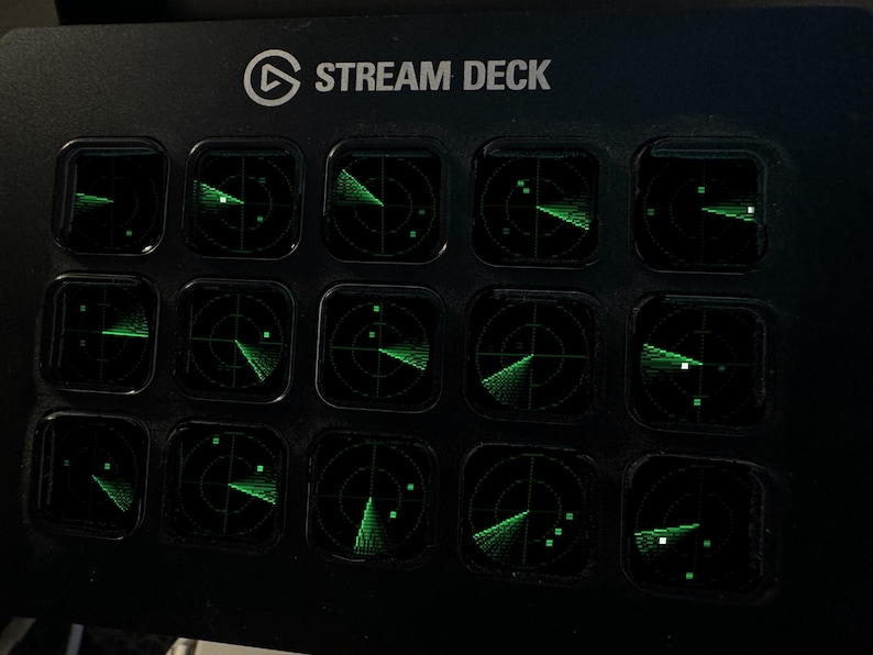 Pode incluir: Uma consola de controlo Stream Deck preta com quinze teclas quadradas dispostas numa grelha. Cada tecla apresenta um gr&aacute;fico de ecr&atilde; de radar verde brilhante com linhas circulares e pequenos pontos quadrados num fundo escuro.