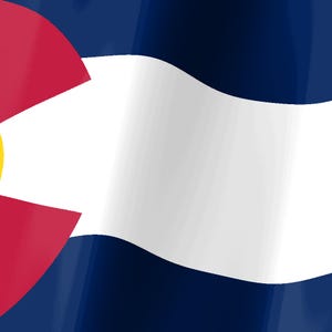 Pode incluir: A bandeira do estado do Colorado apresenta tr&ecirc;s faixas horizontais nas cores azul, branco e azul. No lado esquerdo, uma letra C vermelha envolve um c&iacute;rculo amarelo, representando o sol, sobre o fundo azul e branco do tecido ondulante.