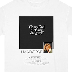 May include: A white t-shirt featuring a black square graphic with the white text "Oh my God, that's my daughter." Below this is a small photo of a person holding their head, the word "HARDCORE," and various film production credits.