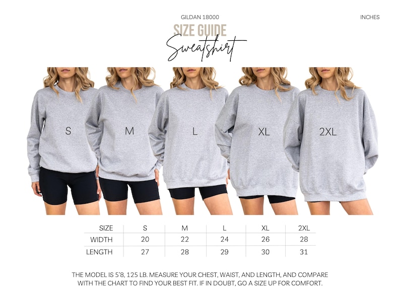 May include: Size guide for a light grey Gildan 18000 sweatshirt. The image shows models wearing sizes S, M, L, XL, and 2XL. The size chart indicates width and length in inches. The text also includes the model's height and weight.