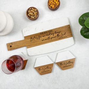 May include: A white and wood serving board with a handle, featuring the text "But as for me and my house, we will serve the Lord." and "The Waltons, Joshua 24:15." Two matching coasters and small bowls of nuts are also visible.