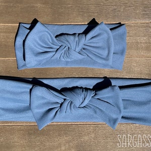 May include: Two blue fabric headbands with a knotted bow. The headband in the foreground is larger than the headband in the background. The text "Sargasso Sea" is visible in the bottom right corner of the image.