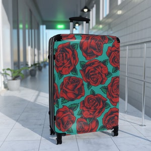 美しいヴィンテージの赤いバラと青緑の背景に車輪付きの荷物、バラの模様のハードシェル旅行用バッグ、ヴィンテージの花柄のカラフルなパターン