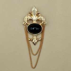 Bergere Fleus De Lis gold toned metal black oval brooch