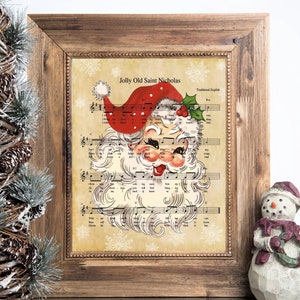 Op de afbeelding: Een vintage kerstprint met een cartoon-kerstman met een rode muts en een witte baard. De print is geplaatst tegen een achtergrond van muzieknoten en sneeuwvlokken. De tekst "Jolly Old Saint Nicholas" is bovenaan de print gedrukt.