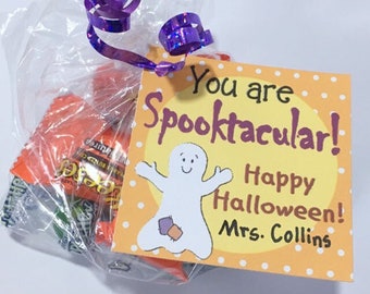 May include: A small orange and white gift bag with a purple ribbon. The bag contains candy. A tag attached to the bag reads "You are Spooktacular! Happy Halloween! Mrs. Collins". The tag features a cartoon ghost.
