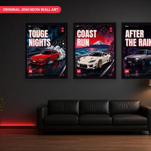 May include: A set of three framed wall art prints featuring JDM car illustrations. The posters display a red car with the text TOUGE NIGHTS, a white car with COAST RUN, and a grey car with AFTER THE RAIN, all set against vibrant neon-style backgrounds.