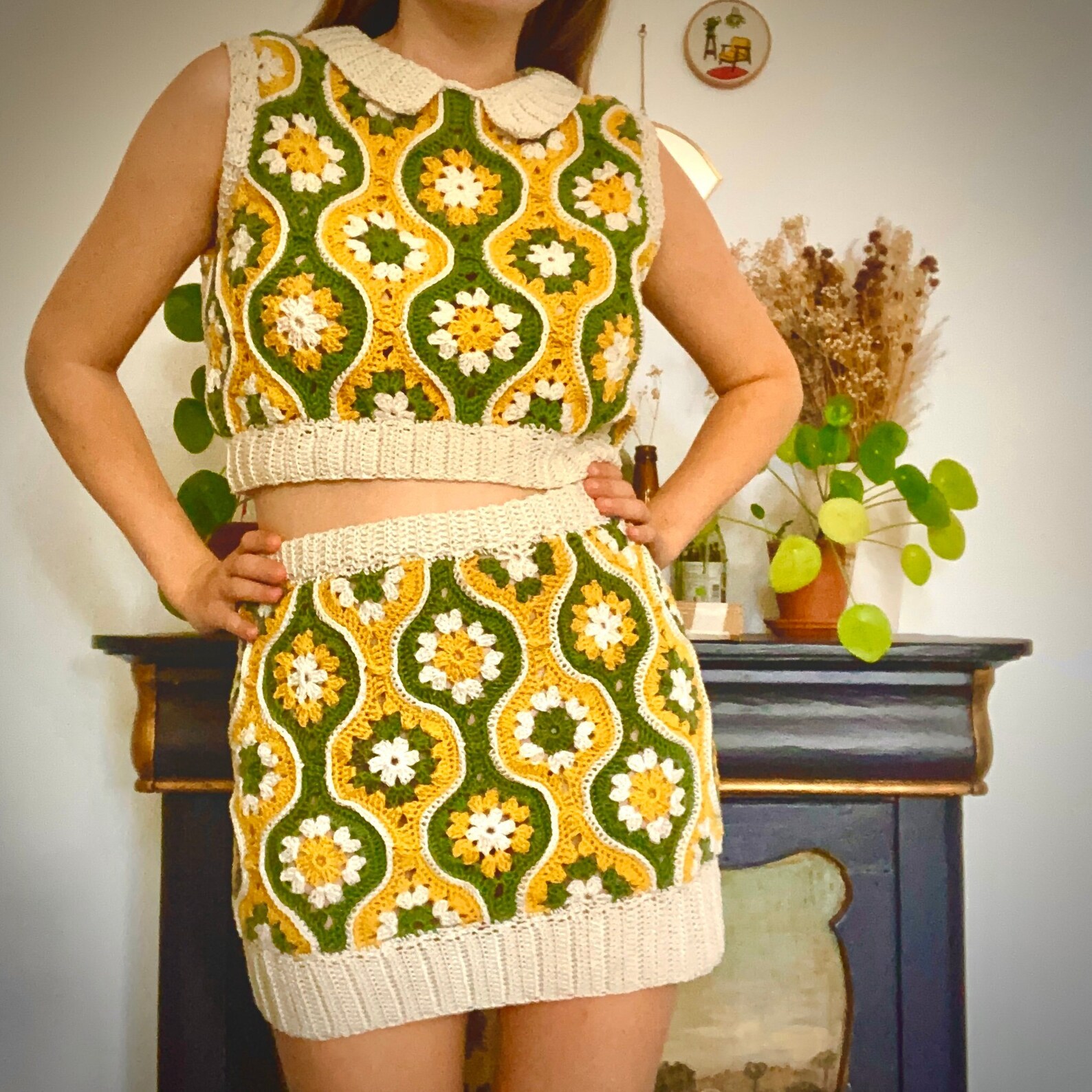 A green, yellow and white tank top and skirt. The design is very 70s with interlocking bubbled columns with flower-like shapes in the center of the bubbles.
