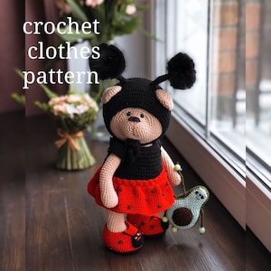 May include: Crochet clothes pattern for a ladybug-themed teddy bear. The bear is wearing a black dress with red polka dots and a black ladybug hat with black pom-poms. The bear is holding a green crocheted avocado.
