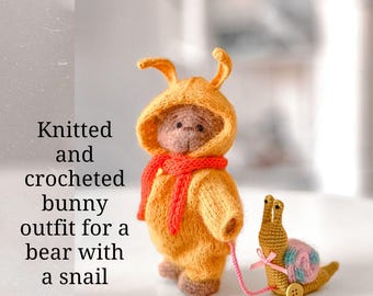 Knitted and crocheted bunny outfit for a bear with a snail
