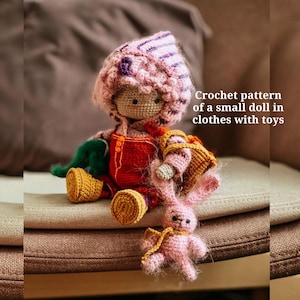 May include: Crocheted doll wearing a pink and purple hooded hat, red dungarees, and yellow boots. The doll is holding a crocheted basket and a pink bunny. "Crochet pattern of a small doll in clothes with toys" is written in the image.