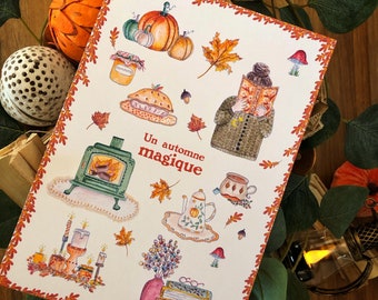 May include: A white card with an orange border features a watercolor illustration of autumnal elements. The text "Un automne magique" is written in black cursive. The illustration includes pumpkins, leaves, a fireplace, a teapot, a book, and candles.