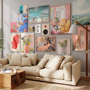May include: A living room featuring a beige sofa and a collection of colourful framed artwork on the wall. The artwork includes abstract designs, landscapes, and animal prints. A wooden floor lamp with a white shade is positioned next to the sofa.