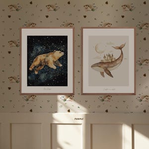 May include: Two framed watercolor illustrations. The first shows a brown bear walking on a starry sky with the text "Big Dipper". The second shows a whale with a castle on its back and the text "Castle in the clouds".