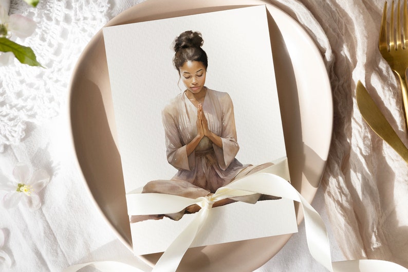May include: A watercolor painting of a person sitting in a meditative pose with their hands clasped in prayer. The person is wearing a light brown robe and has dark hair pulled back in a bun. The painting is on a white card with a white ribbon tied around it.