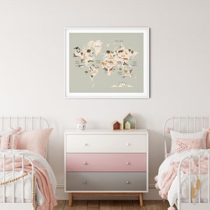 Peut inclure: Une carte du monde vert clair avec des illustrations d'animaux de diff&eacute;rents continents. La carte est encadr&eacute;e de blanc et accroch&eacute;e &agrave; un mur blanc. Deux lits jumeaux en m&eacute;tal blanc avec une literie rose sont de chaque c&ocirc;t&eacute; d'une commode &agrave; trois tiroirs avec un tiroir sup&eacute;rieur blanc, un tiroir central rose et un tiroir inf&eacute;rieur gris.