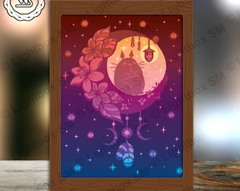 May include: A wooden frame containing a colourful image of a cartoon character sitting on a crescent moon. The image is surrounded by flowers and stars. The background is a gradient of purple, blue and pink.